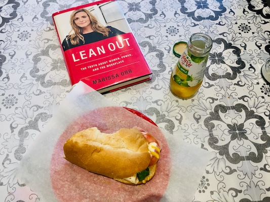 Marissa Orr's book Lean Out rests on a table beside a ham sandwich